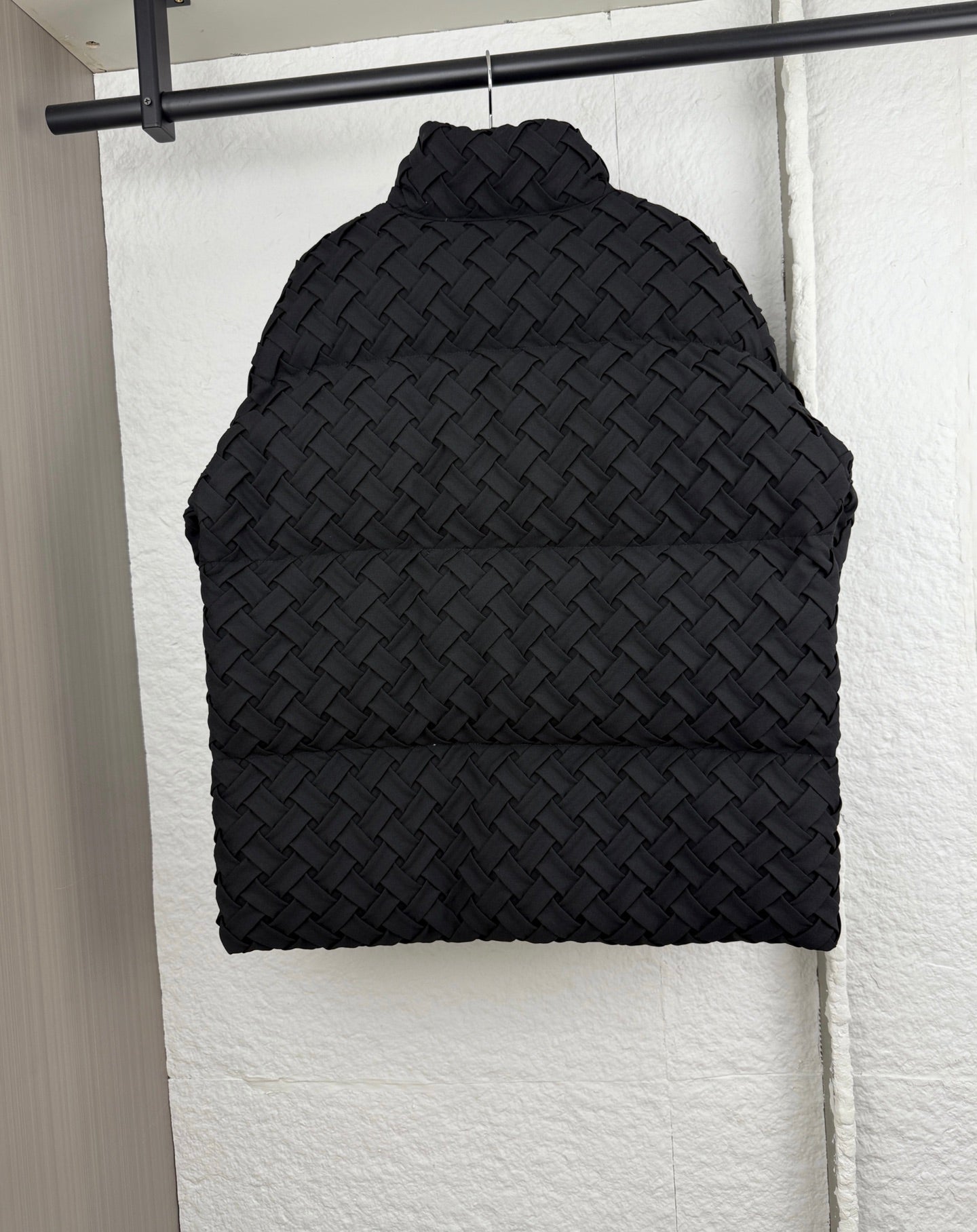 Black woven-texture hood with rounded shape