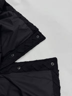 Black jacket cuff with snap strap and woven-texture trim
