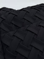 Close-up of black woven-texture jacket fabric panel