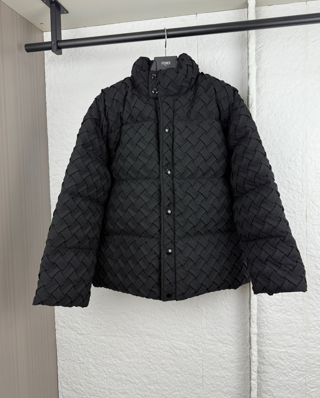 Black woven-texture hooded puffer jacket with front snap buttons
