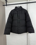 Black woven-texture hooded puffer jacket with front snap buttons