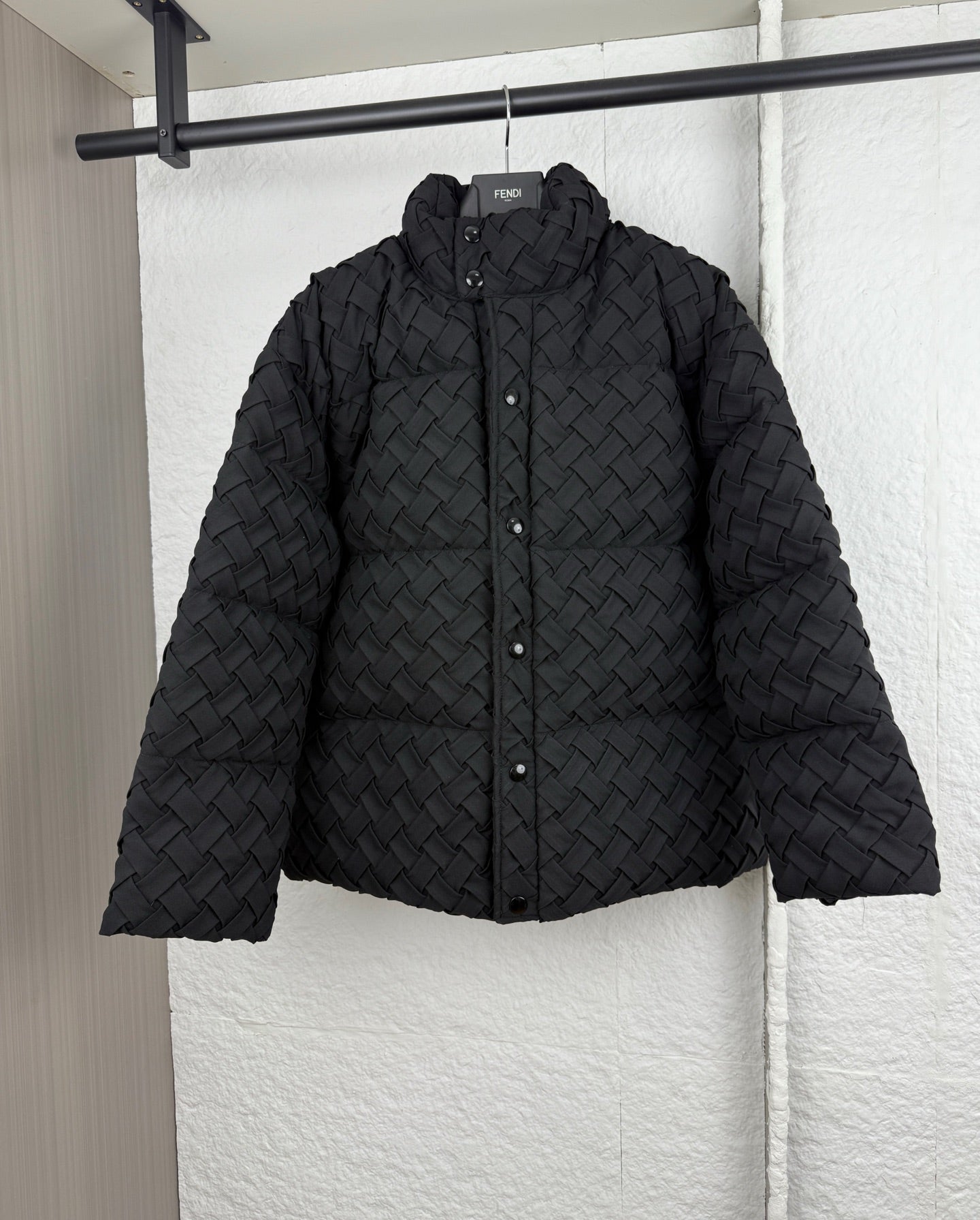 Black woven-texture hooded puffer jacket with front snap buttons