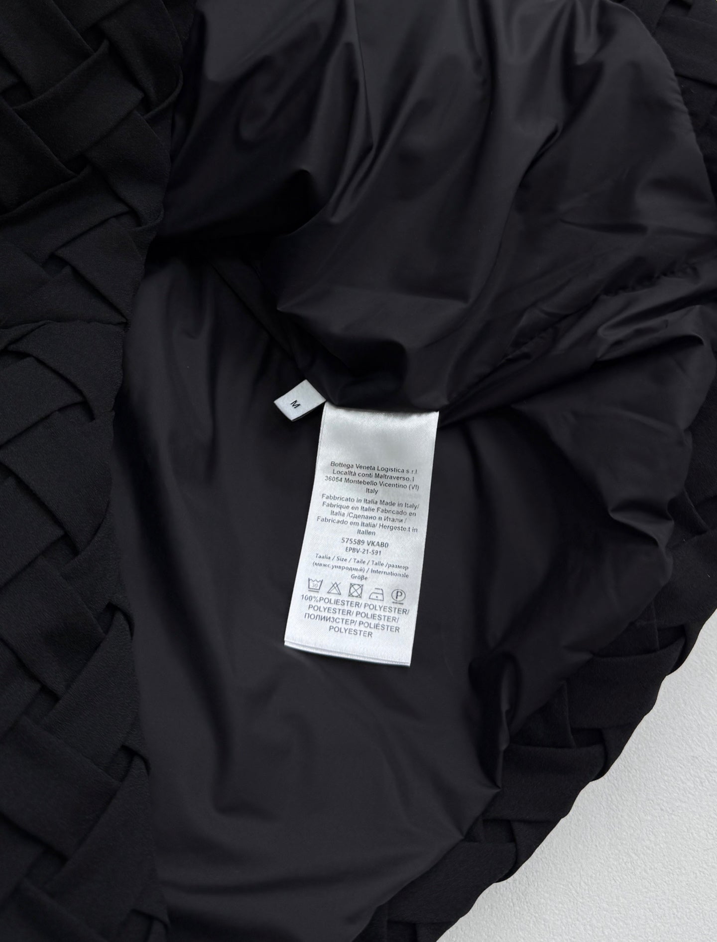 Black jacket interior with care label tag