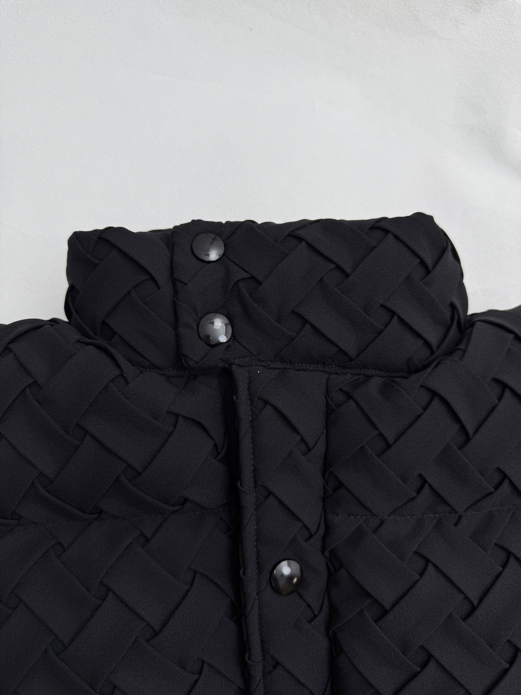 Black hood and front placket with metal snap buttons