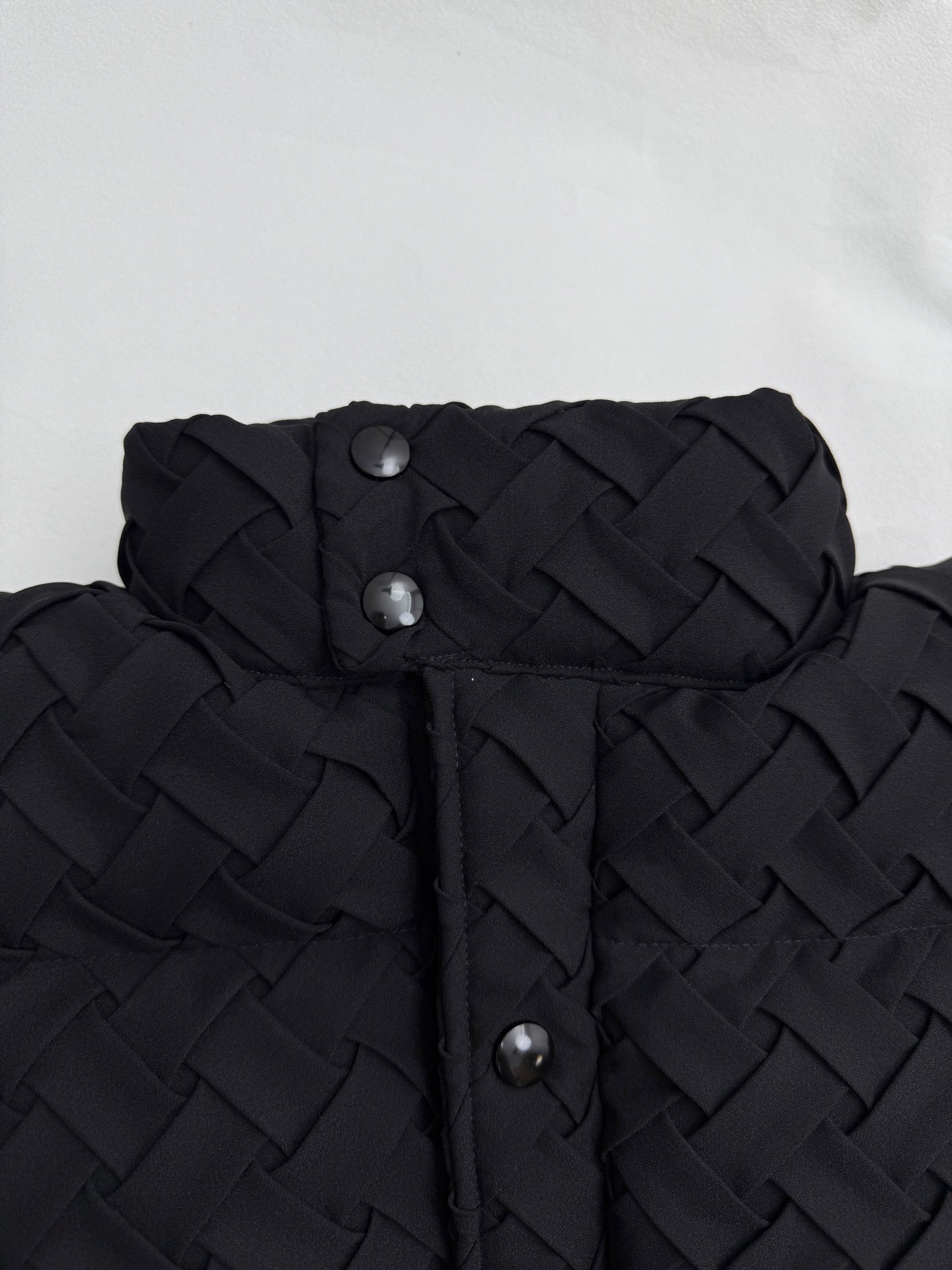 Black hood and front placket with metal snap buttons