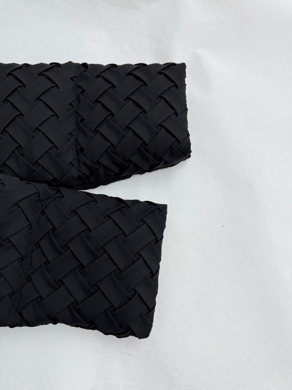 Black hooded jacket sleeves with textured woven pattern