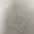 White T-shirt textured embroidered emblem close-up