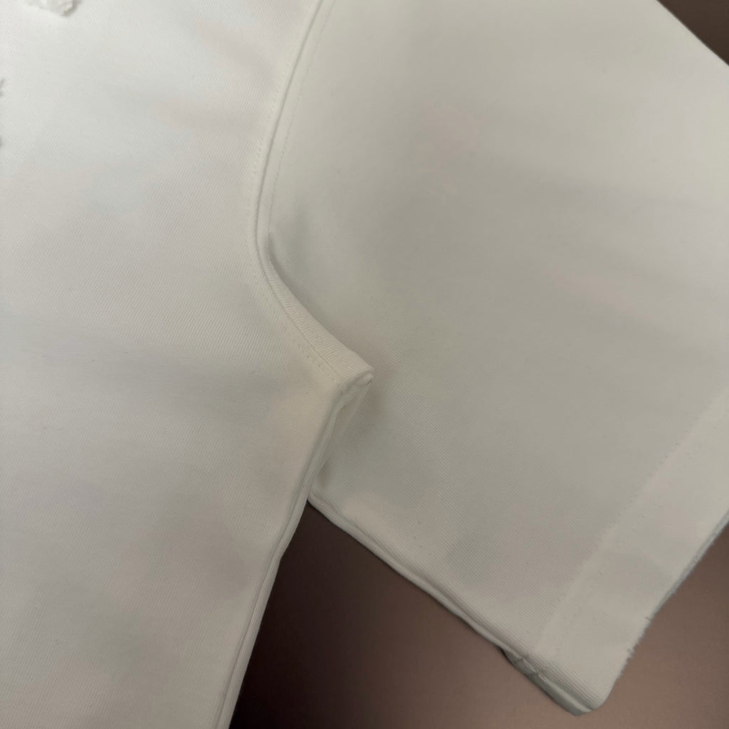White T-shirt sleeve hem and side seam close-up