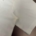 White T-shirt sleeve hem and side seam close-up
