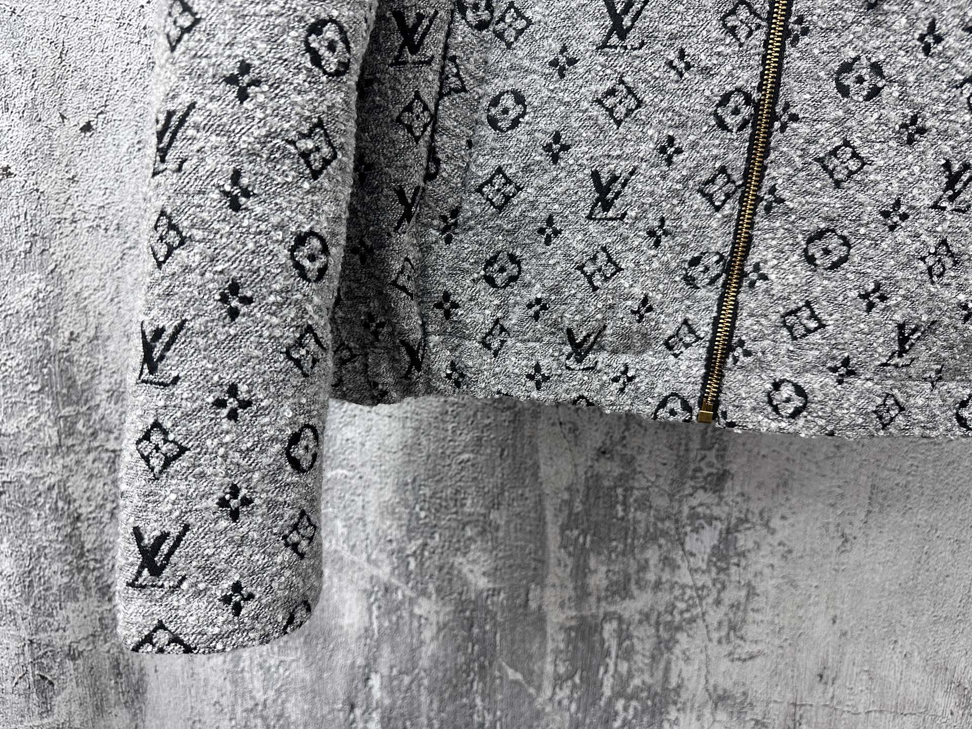 Louis Vuitton hooded jacket lower front close-up in dark gray with monogram and zipper