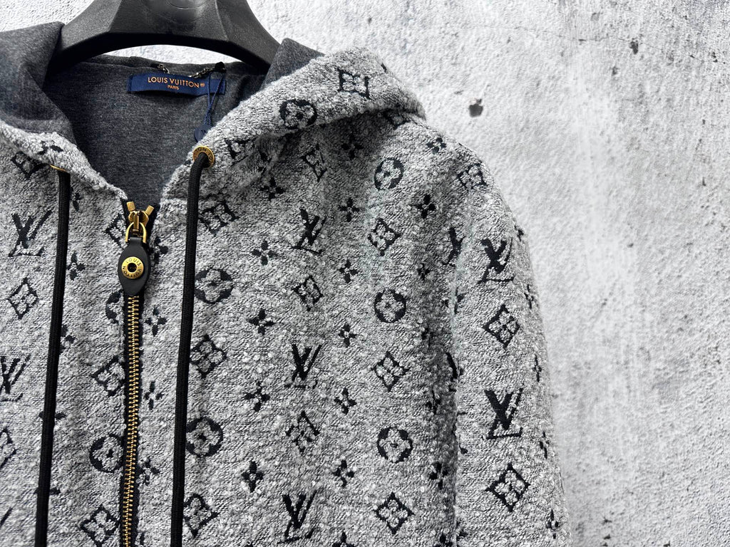 Louis Vuitton hooded jacket close-up: dark gray monogram print, zipper and cord pulls