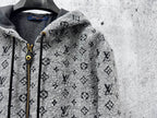 Louis Vuitton hooded jacket close-up: dark gray monogram print, zipper and cord pulls