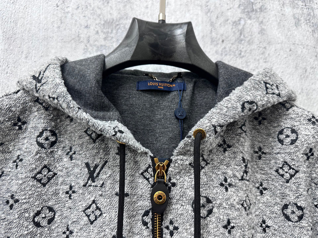 Louis Vuitton hooded jacket neckline close-up with gray lining, zipper, and monogram print