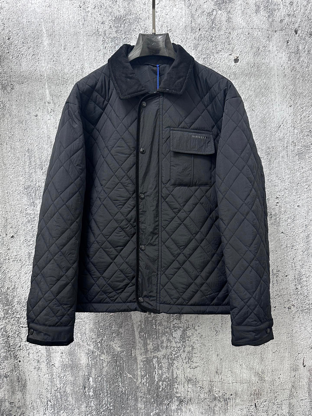 Burberry long quilted jacket with stand collar, button front, and chest pocket