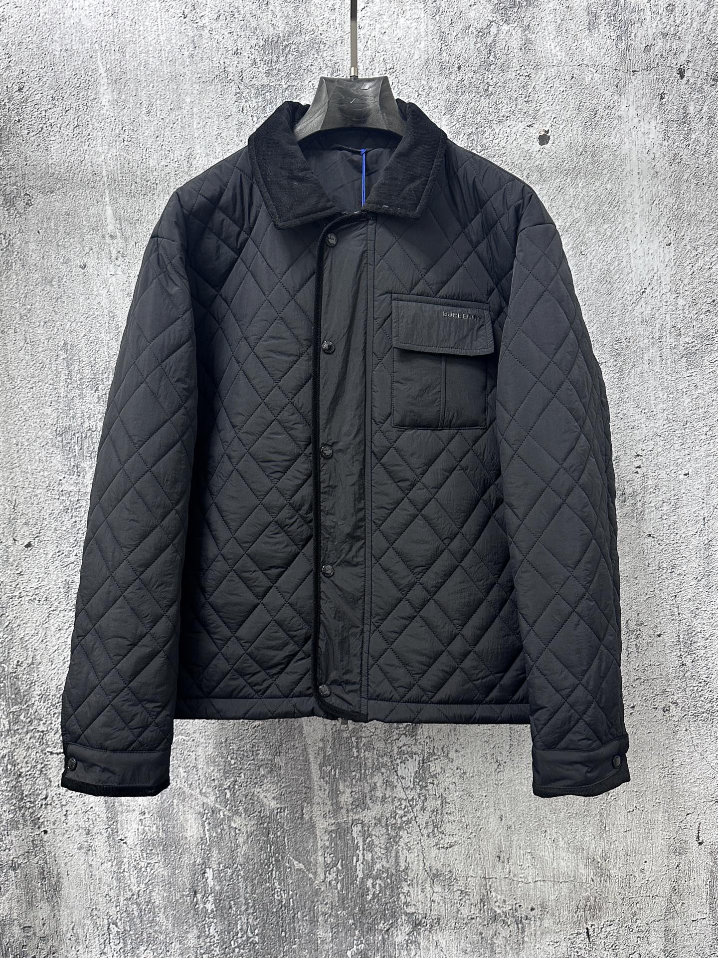 Burberry long quilted jacket with stand collar, button front, and chest pocket