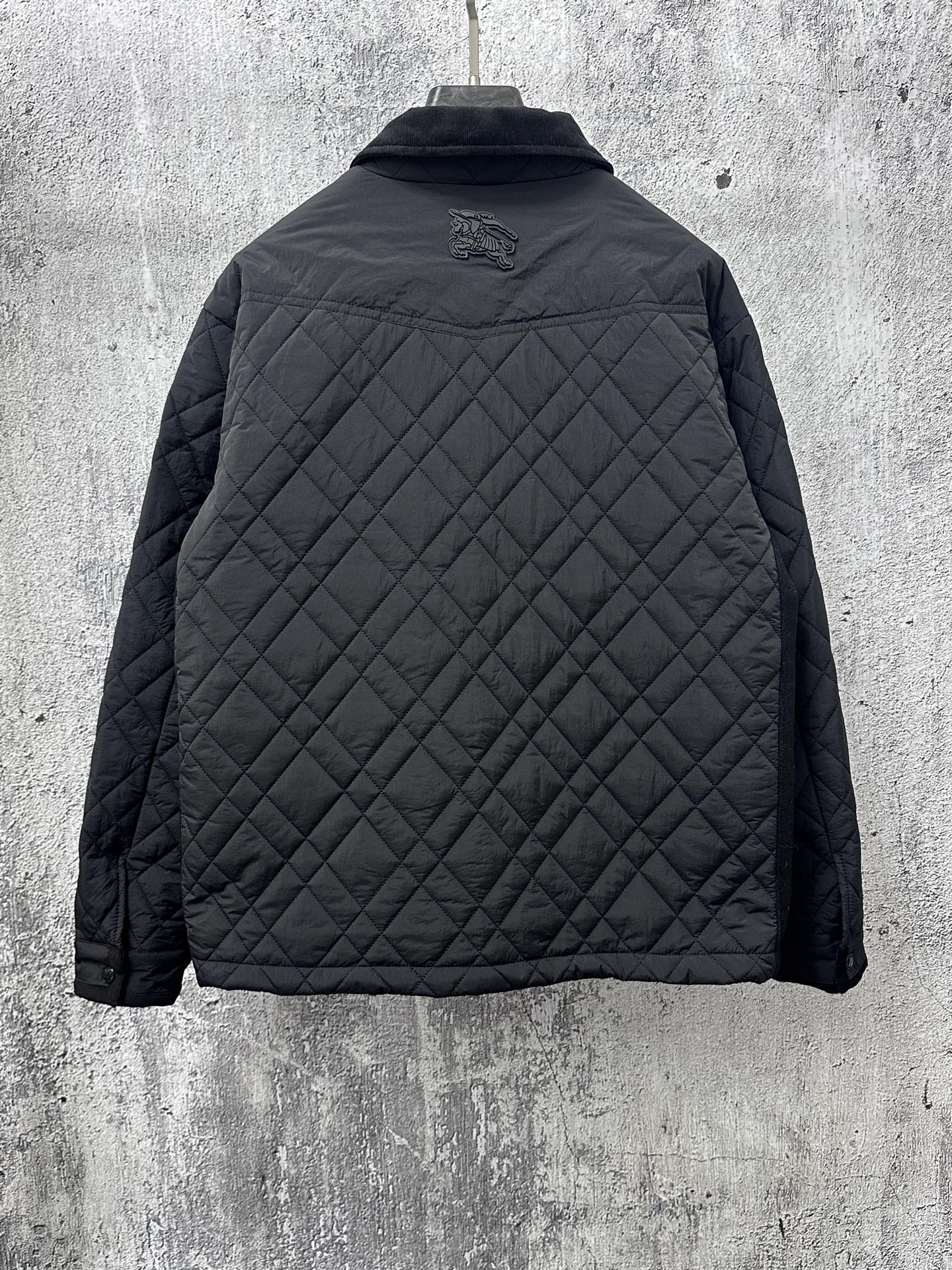 Burberry long quilted jacket, back view with raised logo and stand collar