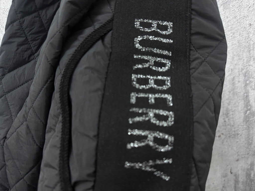 Burberry long jacket interior label text on dark fabric near zipper