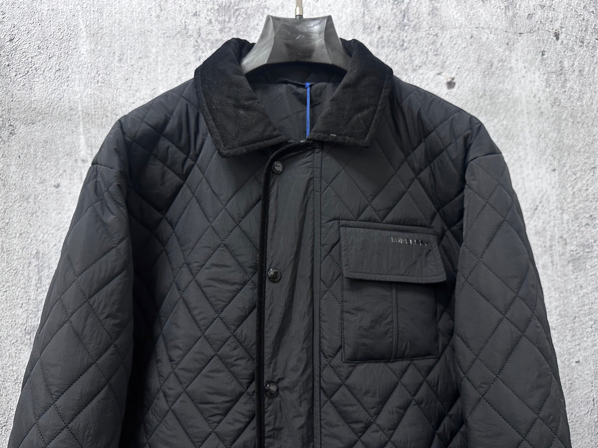 Burberry long quilted jacket front view with stand collar and button placket