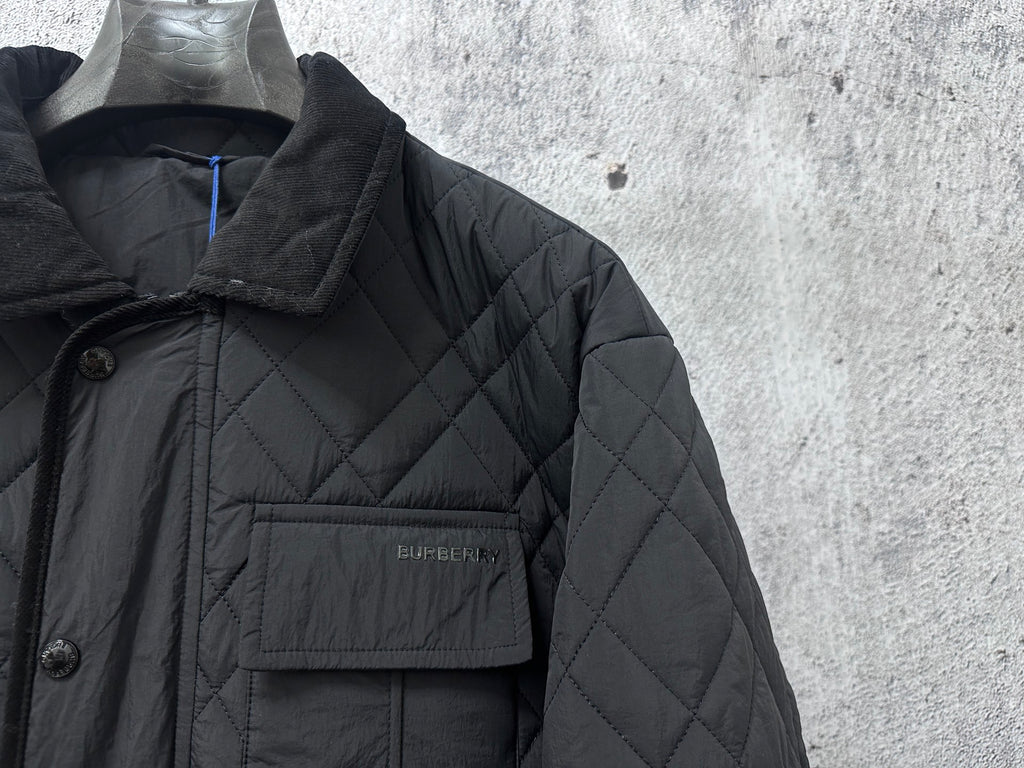 Burberry long quilted jacket chest pocket with logo patch on dark fabric
