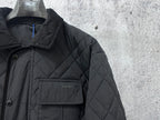 Burberry long quilted jacket chest pocket with logo patch on dark fabric