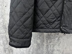 Burberry long quilted jacket side view with ribbed sleeve cuff and button