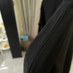 Black sweatshirt fabric and sleeve seam detail