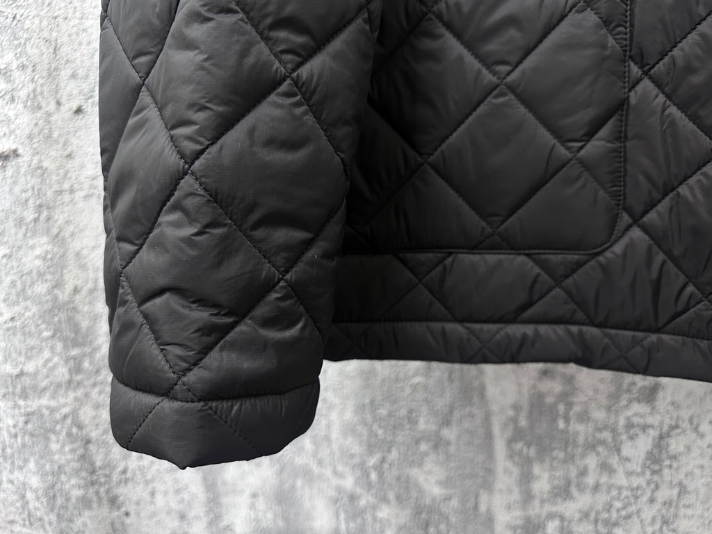 Prada quilted dark long jacket hem with pocket detail and diamond stitching
