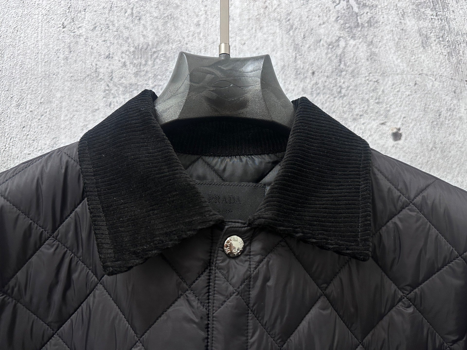 Prada long jacket collar on quilted dark fabric with gold snap