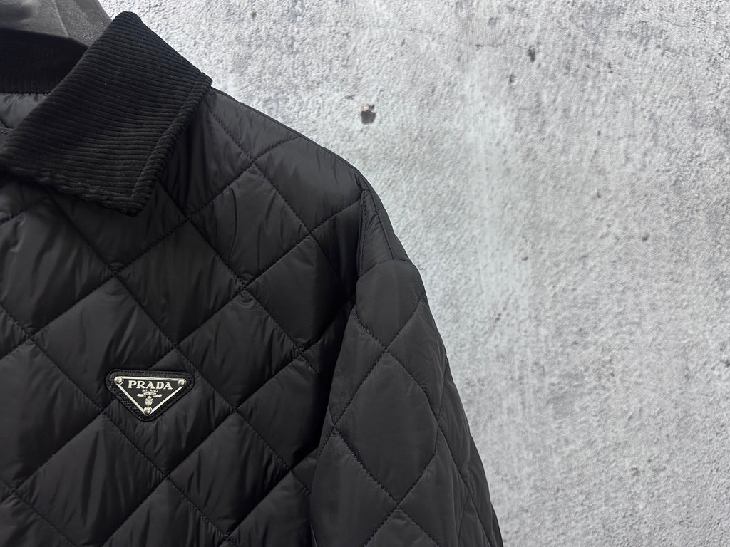 Prada logo badge on quilted dark black long jacket with diamond pattern