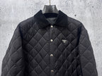 Prada quilted long jacket in dark black with chest logo and snap front