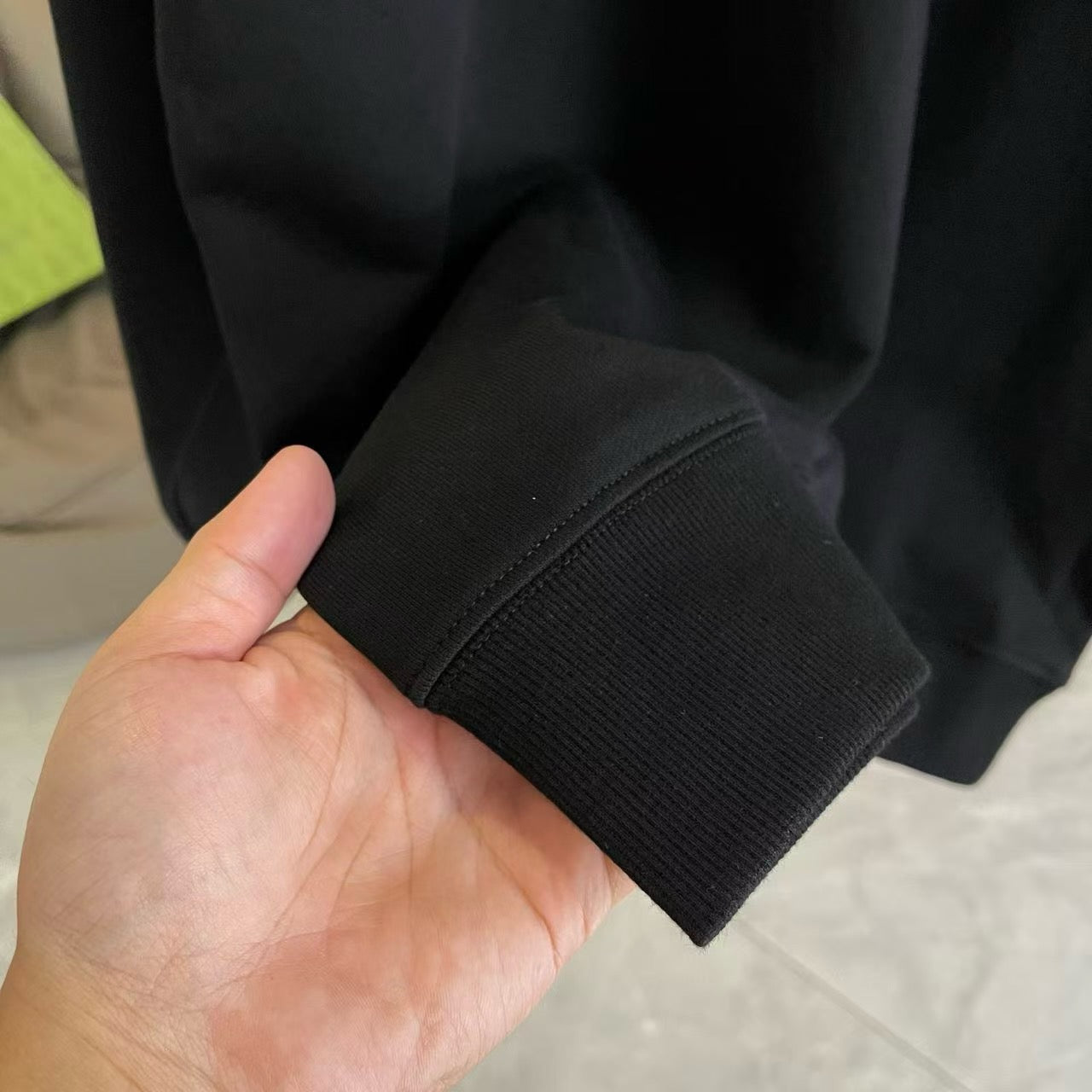 Black sweatshirt cuff hem with ribbed knit, close-up