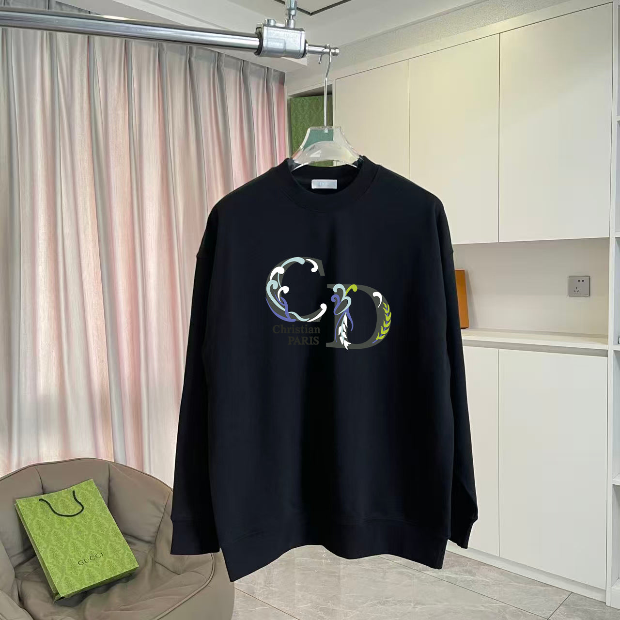 Black long-sleeve crewneck sweatshirt with colorful crest graphic print