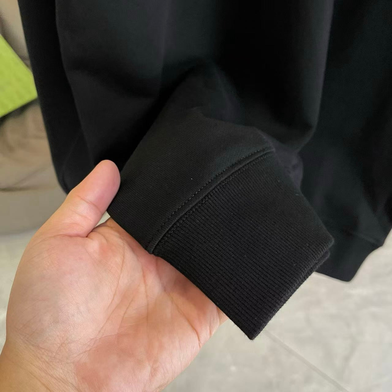 Black sweatshirt cuff and hem with ribbed knit finish