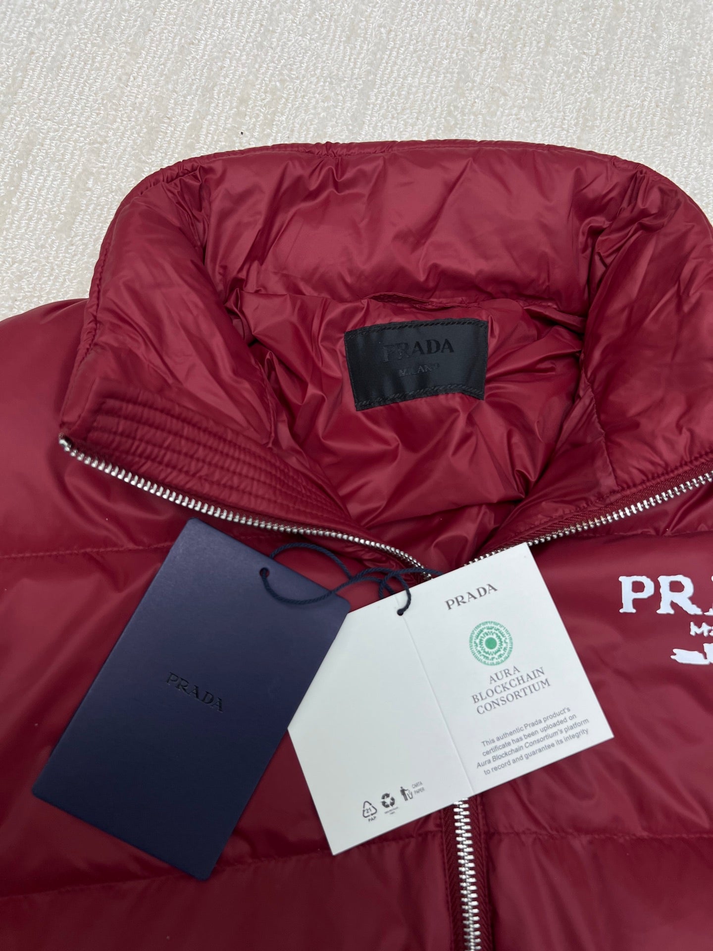 Prada red puffer jacket interior lining with brand label and zipper pull