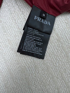 Prada label tag on long padded jacket with size and care text