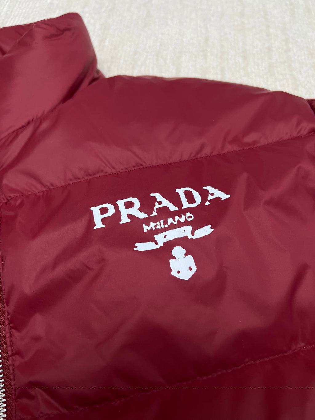 Prada red puffer jacket chest logo graphic and quilted stitch detail