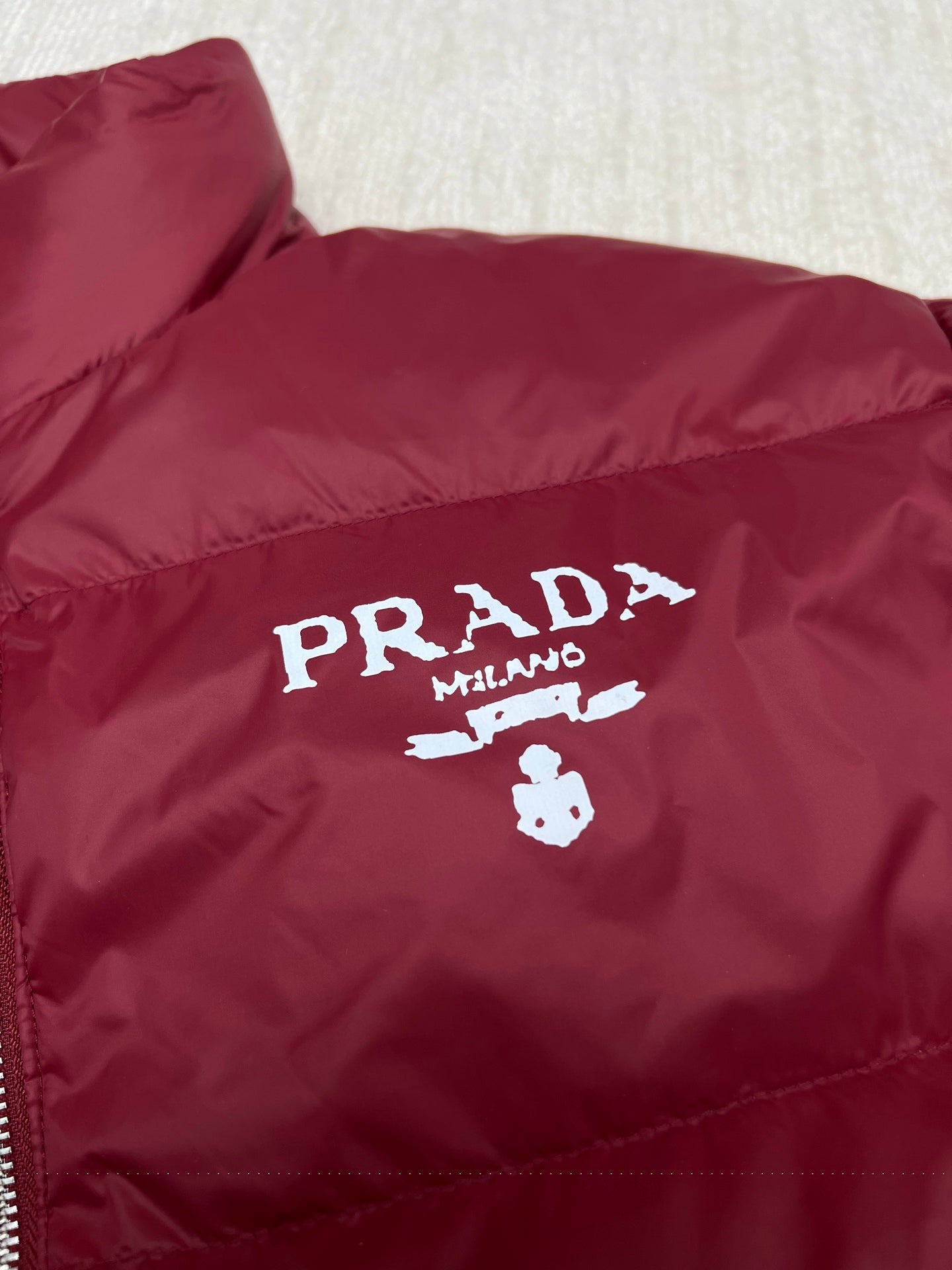 Prada red puffer jacket chest logo graphic and quilted stitch detail