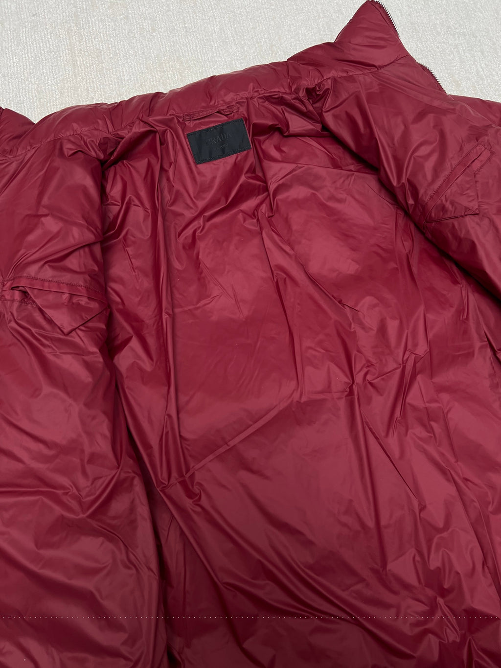 Prada red puffer jacket neckline and inner collar tag