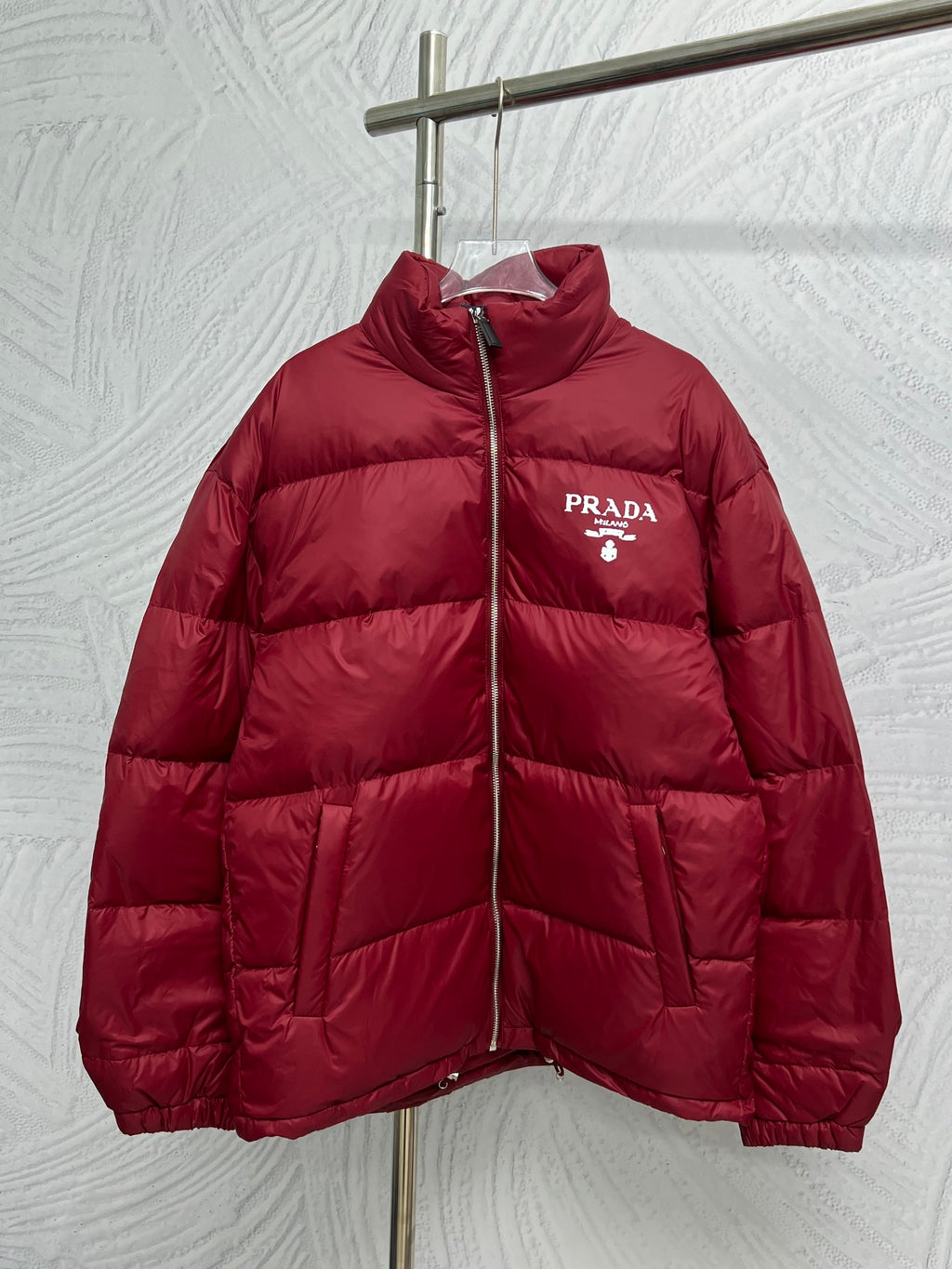 Prada red puffer jacket with front zipper and PRADA logo patch