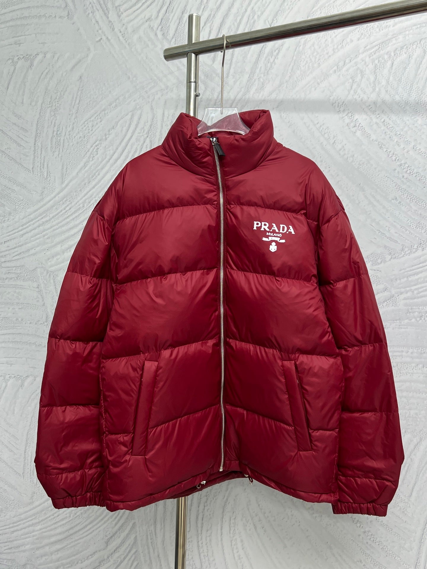 Prada red puffer jacket with front zipper and PRADA logo patch