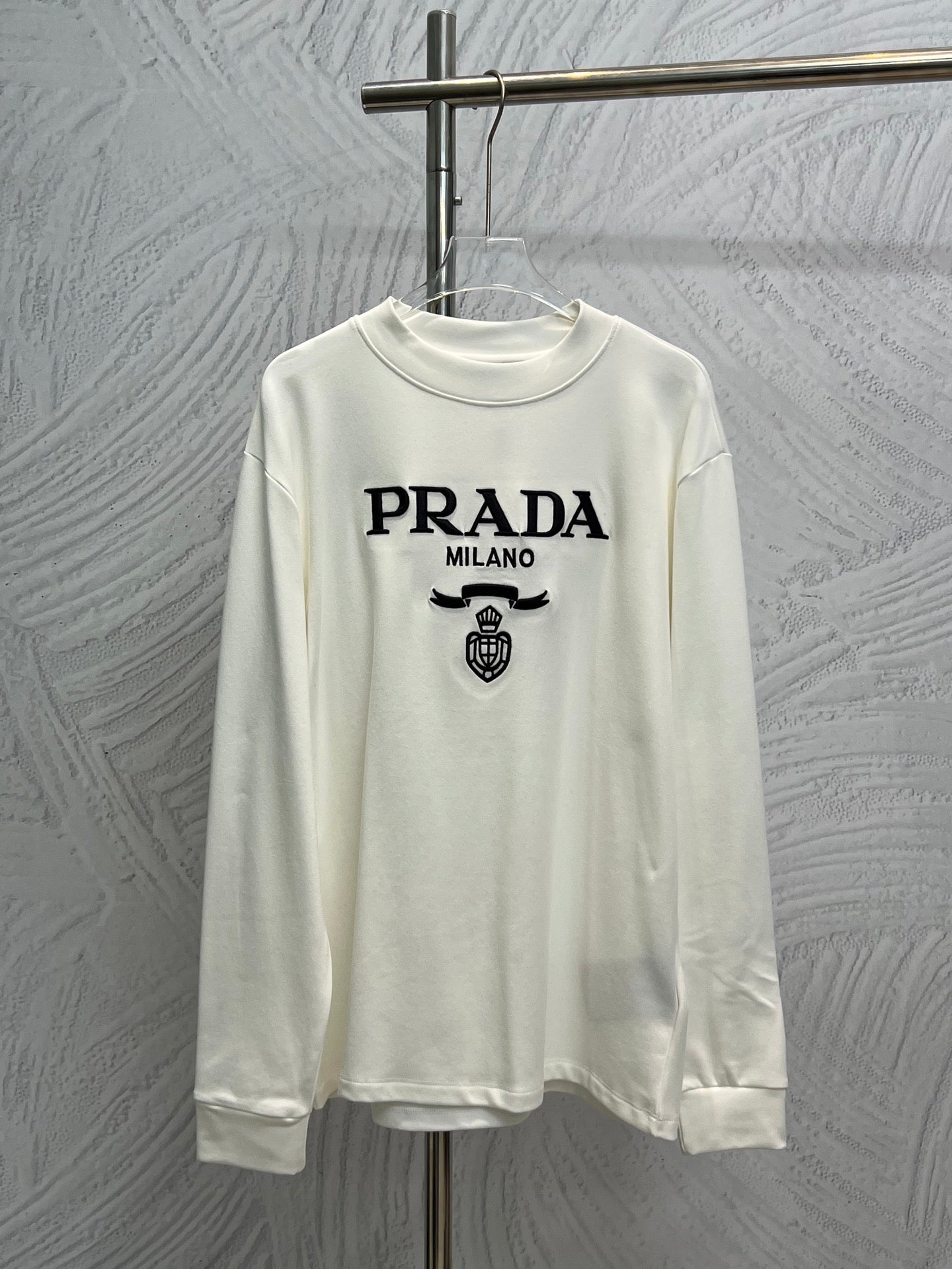 White long-sleeve crewneck shirt with PRADA MILANO logo and crest print