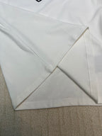 White long-sleeve shirt sleeve and hem seam detail