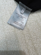 Size and care label on dark sweatshirt, marked S