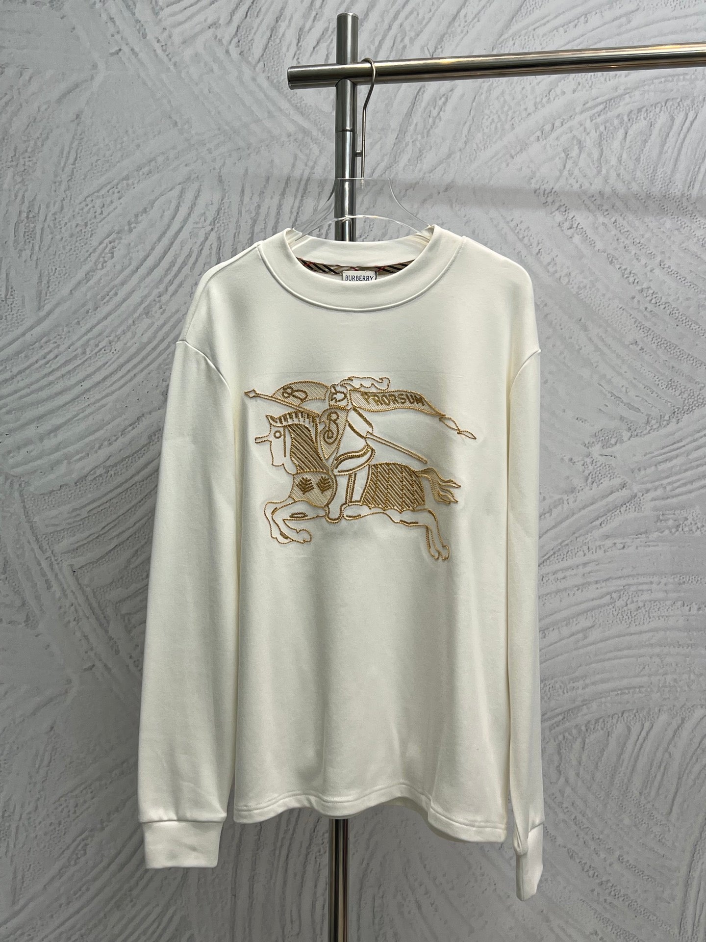 White long-sleeve shirt with gold horse graphic embroidery on the front