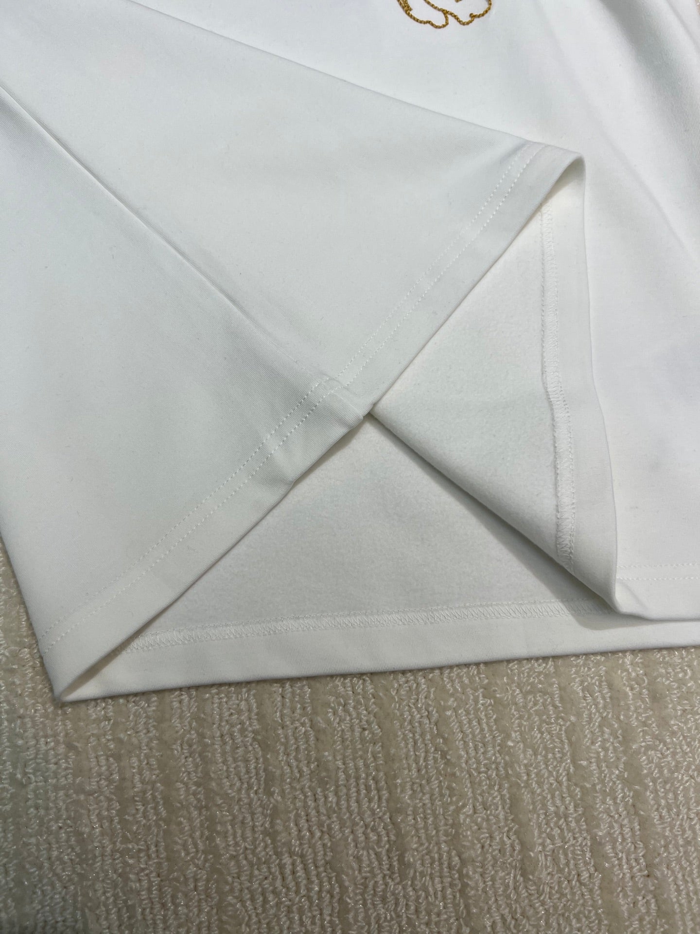 White long-sleeve shirt fabric and hem seam detail
