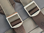 Gray bag with webbing strap and metal buckles featuring Dior labels