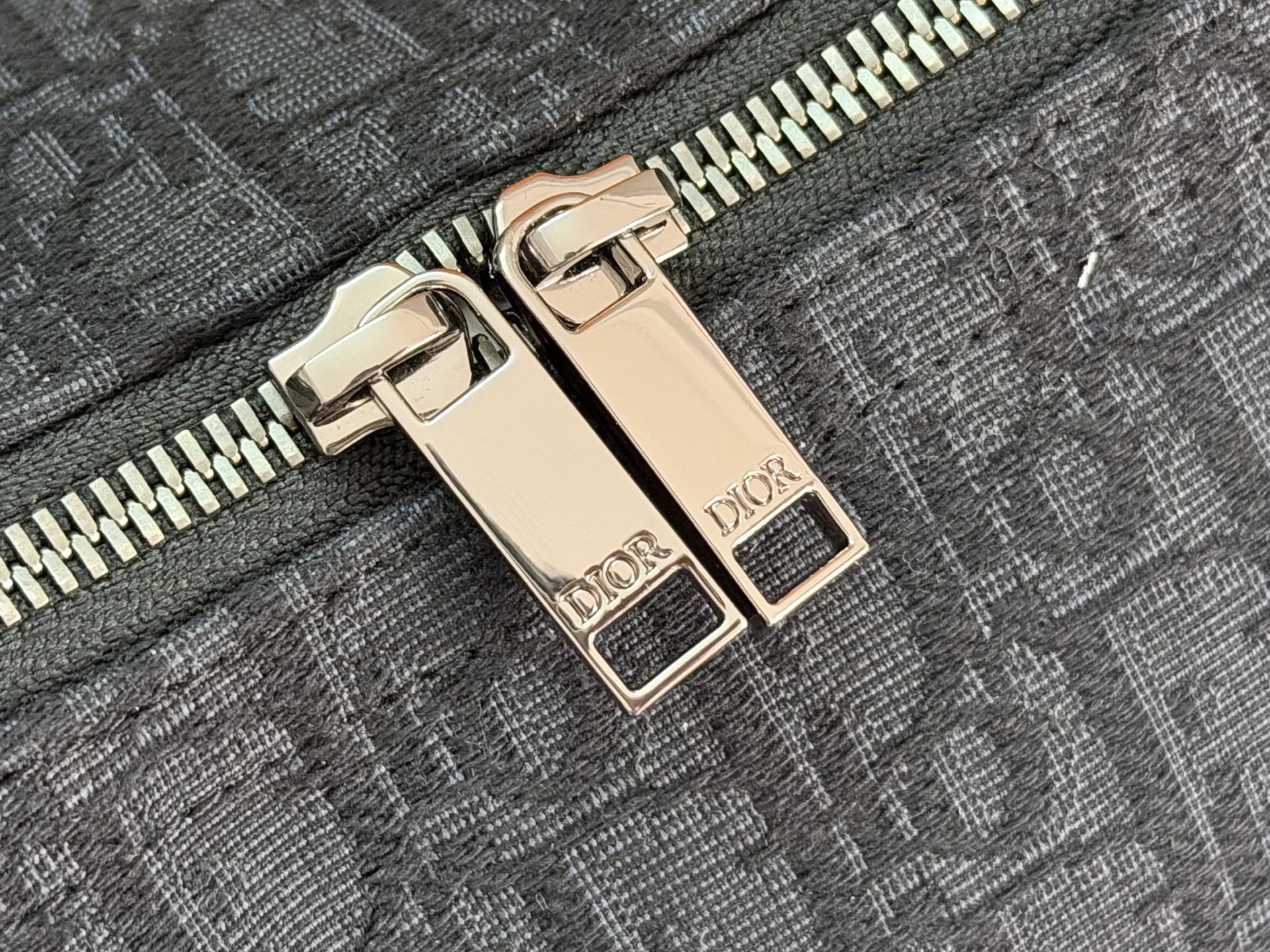 Dior zipper pull set with two gold-tone metal tabs