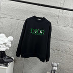 Black long-sleeve crewneck sweatshirt with green DIOR logo on chest