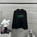 Black crewneck sweatshirt with long sleeves and green DIOR logo