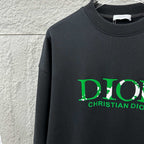 Black sweatshirt close-up with green DIOR and CHRISTIAN DIOR print
